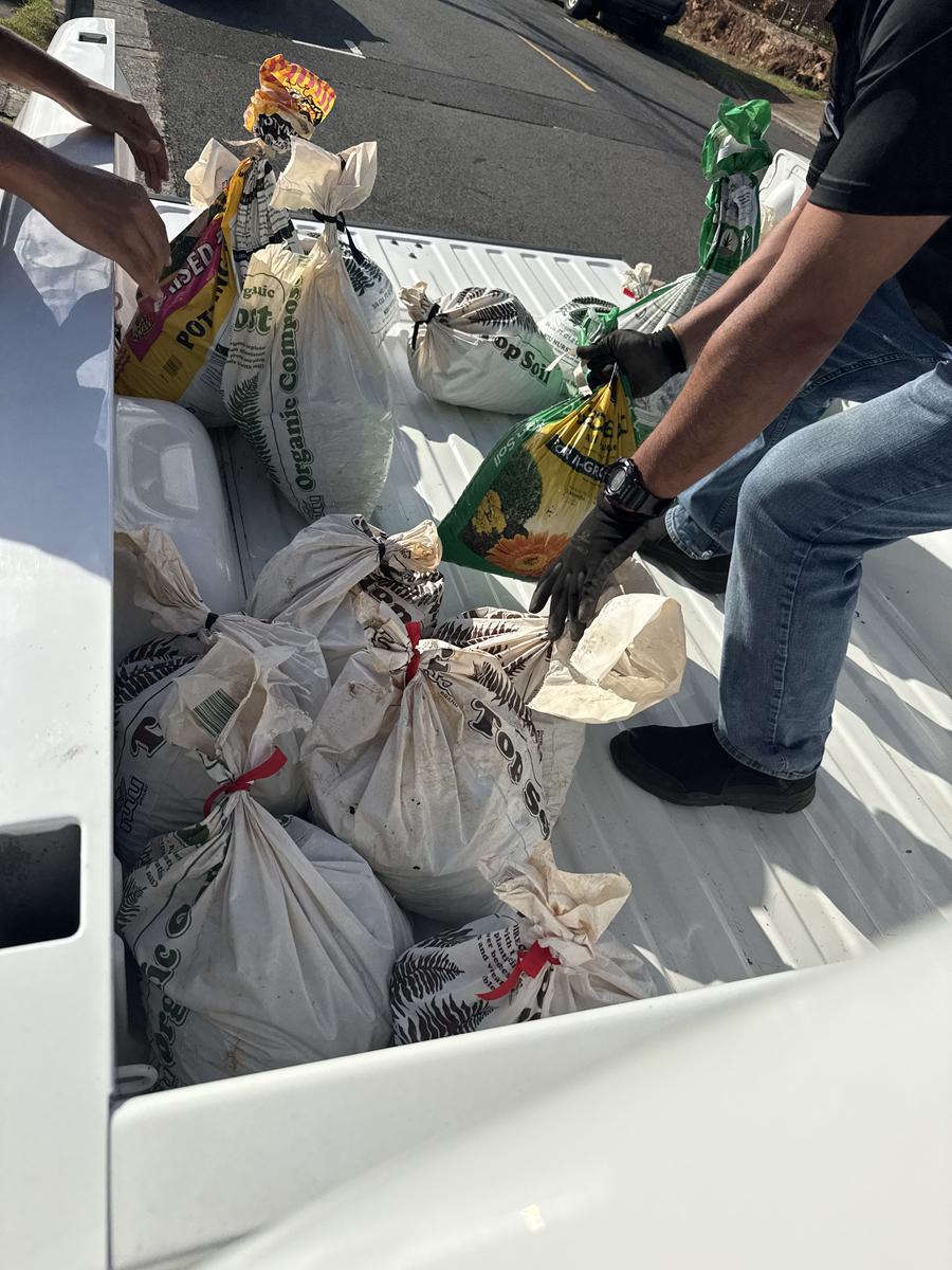 ʻŌpala Kuleana crew loading junk into truck on Oahu